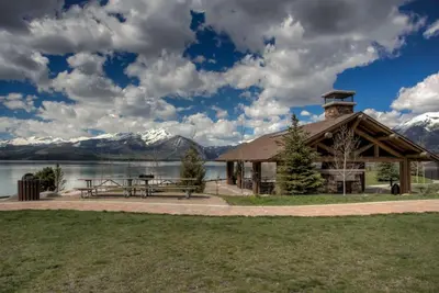 a pavilion with a picnic table and a lake at Pool and Hot Tubs, On Lake Dillon, Beautiful Views in Dillon