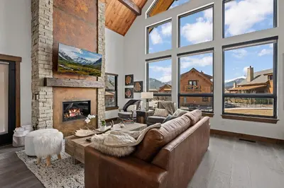 a living room with a couch and a fireplace at Cabin on Lake Estes! Private Jacuzzi Two Patios Indoor and Outdoor Fireplace in Estes Park