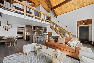 a living room with a couch and a table at Fantastic Views Two Large Patios Private Jacuzzi and Indoor Outdoor Fireplace in Estes Park