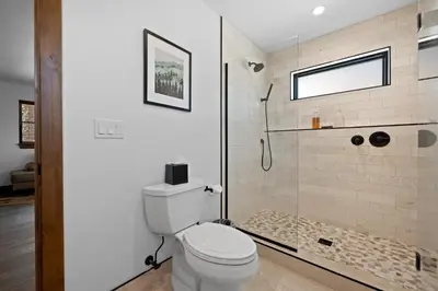 a bathroom with a toilet and a shower at Fantastic Views Two Large Patios Private Jacuzzi and Indoor Outdoor Fireplace in Estes Park