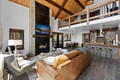 a living room with a couch and a fireplace at Fantastic Views Two Large Patios Private Jacuzzi and Indoor Outdoor Fireplace in Estes Park