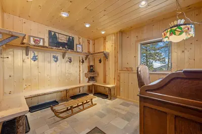 a room with a piano and wooden walls at Mounticello Log Cabin - Relaxing Front Patio & Outdoor Firepit in Estes Park