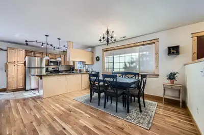 a kitchen and dining room with a table and chairs at Moon Creek Cabin cabin in Nederland