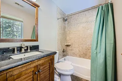 a bathroom with a sink and a toilet and a tub at Moon Creek Cabin cabin in Nederland