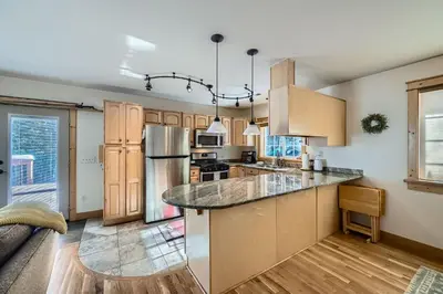 a kitchen with wooden cabinets and a counter top at Moon Creek Cabin cabin in Nederland