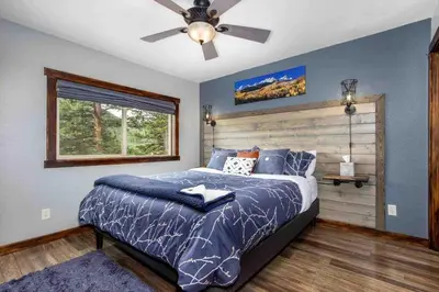 a bedroom with a bed and a ceiling fan at Lux 3BR Home - Wildlife & Views near RMNP in Estes Park