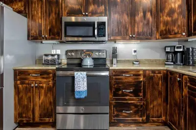 a kitchen with a stove and a microwave at Lux 3BR Home - Wildlife & Views near RMNP in Estes Park