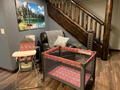 a living room with a chair and a staircase at Lux 3BR Home - Wildlife & Views near RMNP in Estes Park
