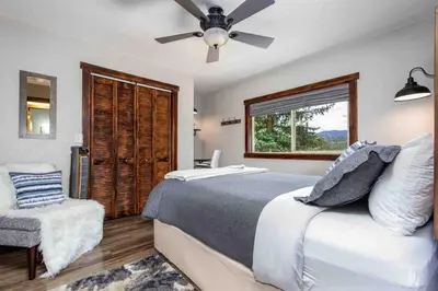a bedroom with a bed and a ceiling fan at Lux 3BR Home - Wildlife & Views near RMNP in Estes Park