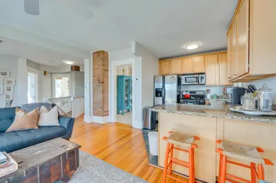 a kitchen and living room with a blue couch at 1 Mi to CU Boulder Condo Near Pearl Street! in Boulder