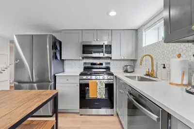 a kitchen with a stainless steel stove and a sink at Urban Hideaway - 2BR - Pets OK - Park 2 Cars - Laundry - Fast WIFI - Close to Everything in Denver