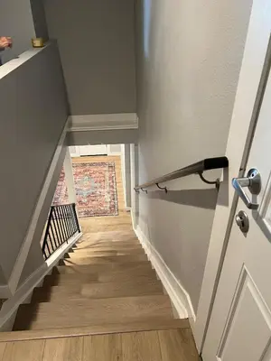 a hallway with a staircase with wood floors and a door at Urban Hideaway - 2BR - Pets OK - Park 2 Cars - Laundry - Fast WIFI - Close to Everything in Denver