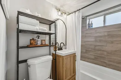 a bathroom with a toilet and a sink and a tub at Urban Hideaway - 2BR - Pets OK - Park 2 Cars - Laundry - Fast WIFI - Close to Everything in Denver