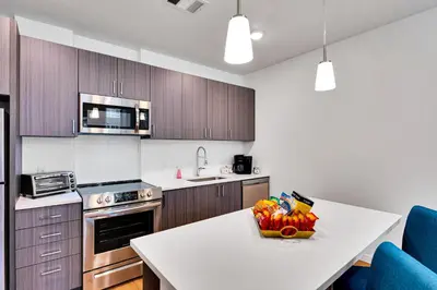 a kitchen with a table with a bowl of food on it at My Sweet Rentals- 30 night min in Aurora