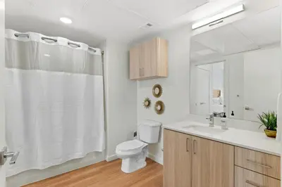 a white bathroom with a toilet and a sink at My Sweet Rentals- 30 night min in Aurora