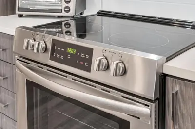 a stainless steel oven in a kitchen with a microwave at My Sweet Rentals- 30 night min in Aurora