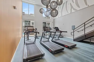 a gym with treadmills and ellipticals in a room at My Sweet Rentals- 30 night min in Aurora