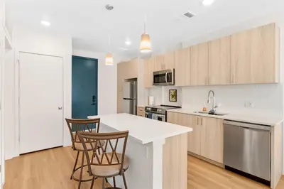 a kitchen with white countertops and wooden cabinets at My Sweet Rentals- 30 night min in Aurora
