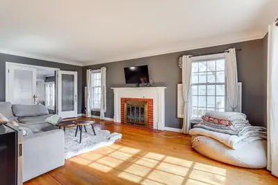 a living room with a couch and a fireplace at Half-Mi to UNC Historic Dtwn Greeley Home in Greeley