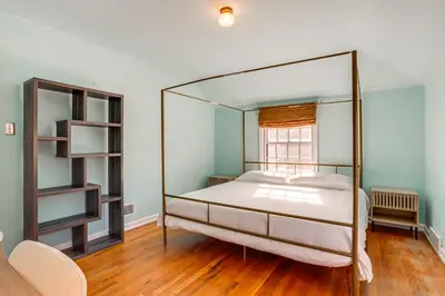 a bedroom with a canopy bed and a window at Half-Mi to UNC Historic Dtwn Greeley Home in Greeley
