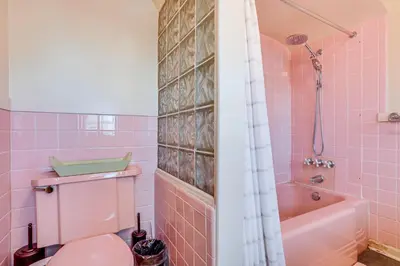 a pink bathroom with a pink toilet and a tub at Half-Mi to UNC Historic Dtwn Greeley Home in Greeley