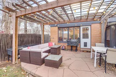 a patio with a wooden pergola and a table and chairs at Half-Mi to UNC Historic Dtwn Greeley Home in Greeley
