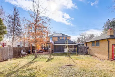 a yard with a swing in front of a house at Half-Mi to UNC Historic Dtwn Greeley Home in Greeley