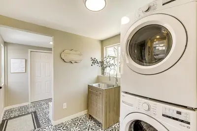 a laundry room with a washer and dryer at Less Than 1 Mi to Olde Town Arvada Home with Patio! in Arvada