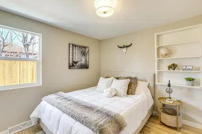 a bedroom with a white bed and a window at Less Than 1 Mi to Olde Town Arvada Home with Patio! in Arvada