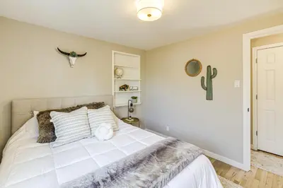 a bedroom with a bed and a cactus on the wall at Less Than 1 Mi to Olde Town Arvada Home with Patio! in Arvada