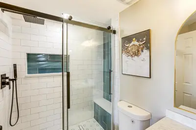 a bathroom with a glass shower and a toilet at Less Than 1 Mi to Olde Town Arvada Home with Patio! in Arvada