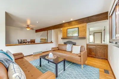 a living room with a couch and a table at 2 Mi to CU Boulder Townhome with Private Deck! in Boulder