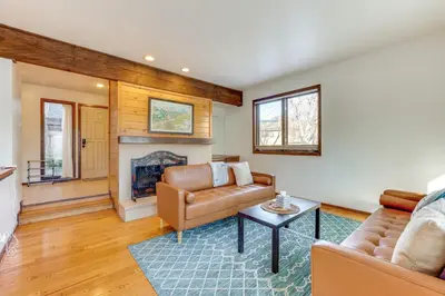 a living room with a couch and a fireplace at 2 Mi to CU Boulder Townhome with Private Deck! in Boulder