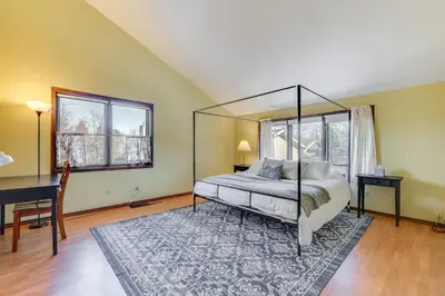 a bedroom with a canopy bed and a desk at 2 Mi to CU Boulder Townhome with Private Deck! in Boulder