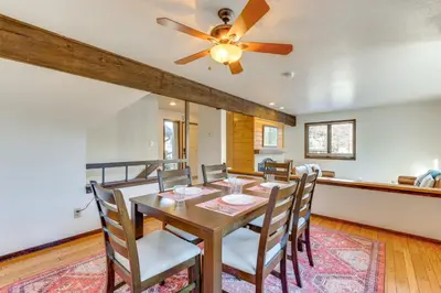 a dining room with a table and chairs and a ceiling fan at 2 Mi to CU Boulder Townhome with Private Deck! in Boulder