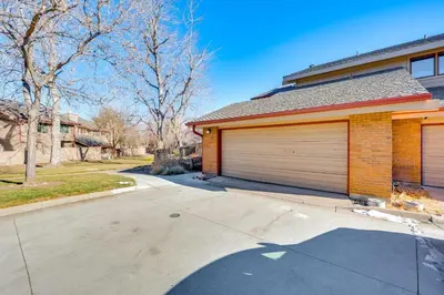 a house with two garage doors on a driveway at 2 Mi to CU Boulder Townhome with Private Deck! in Boulder