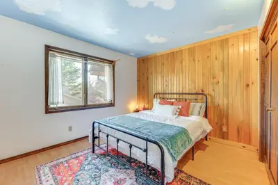a bedroom with a bed and a window at 2 Mi to CU Boulder Townhome with Private Deck! in Boulder