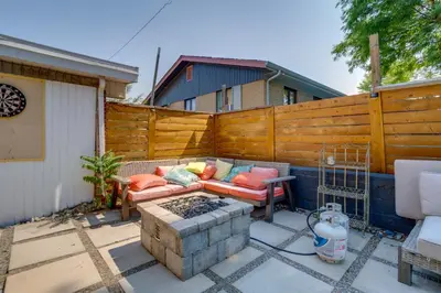 a patio with a couch and a fire pit at 10 Mi to Red Rocks Denver Home with Fire Pit! in Denver