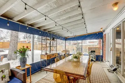 a large room with a wooden table and chairs at 10 Mi to Red Rocks Denver Home with Fire Pit! in Denver