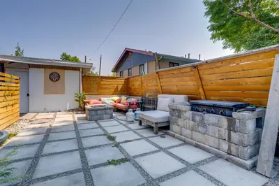 a patio with a grill and a fence at 10 Mi to Red Rocks Denver Home with Fire Pit! in Denver