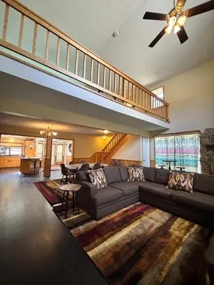 a living room with a couch and a staircase at Yogi Bear's Jellystone Park Camp-Resort in Estes Park in Estes Park