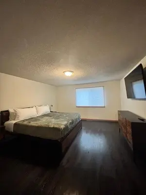 a bedroom with a large bed and a window at Yogi Bear's Jellystone Park Camp-Resort in Estes Park in Estes Park