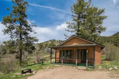 a small house in the middle of a field at Yogi Bear's Jellystone Park Camp-Resort in Estes Park in Estes Park