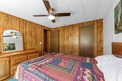 a bedroom with a bed and a ceiling fan at Yogi Bear's Jellystone Park Camp-Resort in Estes Park in Estes Park