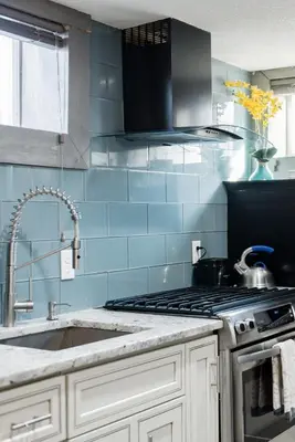 a kitchen with a sink and a stove top oven at Designer Apartment in a Historic 1901 Downtown Area Mansion in Denver