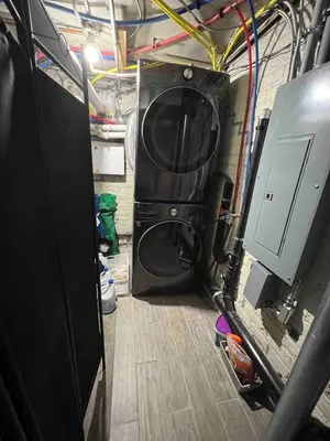 a garage with a washer and dryer in it at Designer Apartment in a Historic 1901 Downtown Area Mansion in Denver