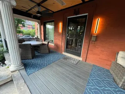 a porch with a table and chairs on a building at 4 BR Luxurious-Gem Mansion in Heart of Denver in Denver