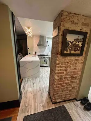 a kitchen with a brick wall and a white counter at 4 BR Luxurious-Gem Mansion in Heart of Denver in Denver