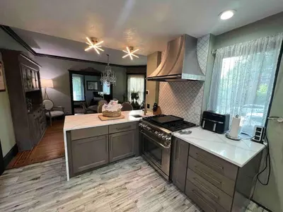 a kitchen with a stove and a counter top at 4 BR Luxurious-Gem Mansion in Heart of Denver in Denver