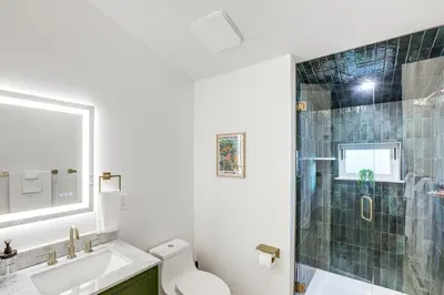 a bathroom with a toilet and a sink and a shower at Less Than 1 Block to City Park New-Build Apt in Denver! in Denver